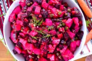 Russian Ukrainian Salad with carrots, beets, dill on Russian table runner