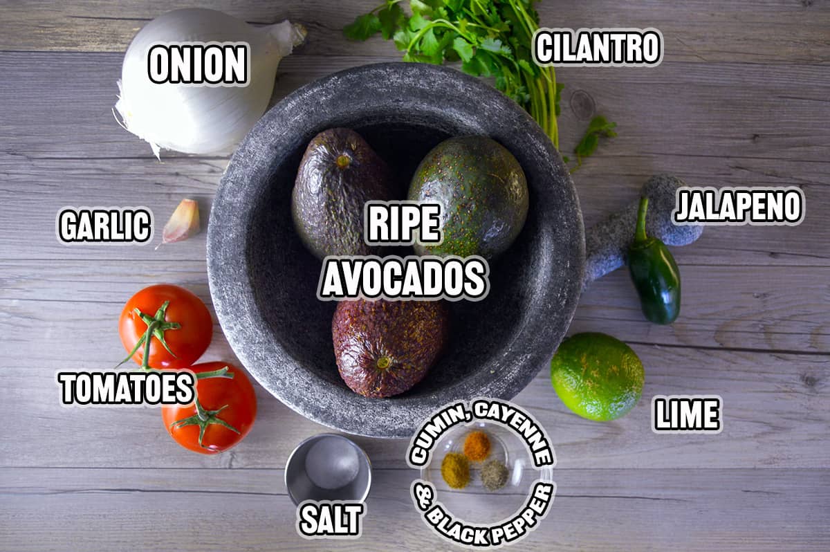 Ingredients for homemade guacamole on grey wooden counter