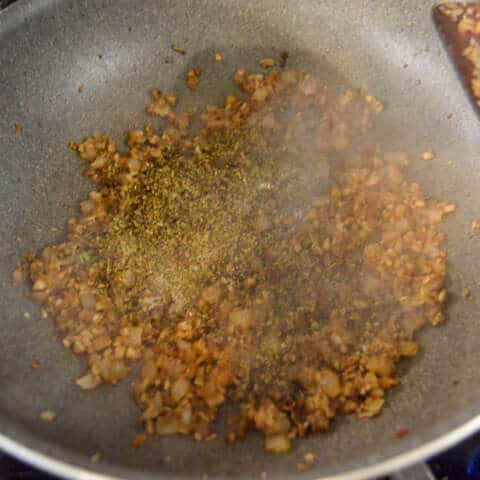Adding spices to stuffed mushroom mixture