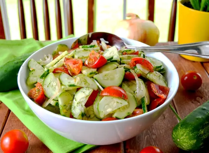 Cucumber Tomato Summer Salad with Dill and onion in serving bowl