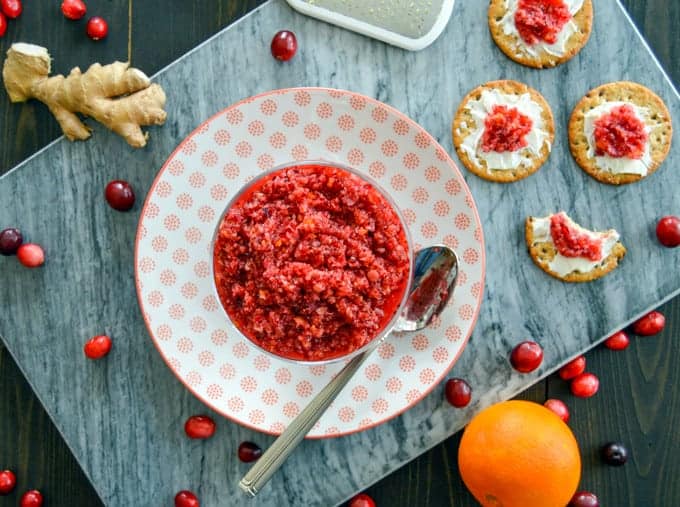 Raw Ginger Orange Cranberry Relish plated with crackers and cream cheese on the side