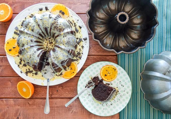 Orange Chocolate Bundt Cake over the top view with a slice and bundt pans
