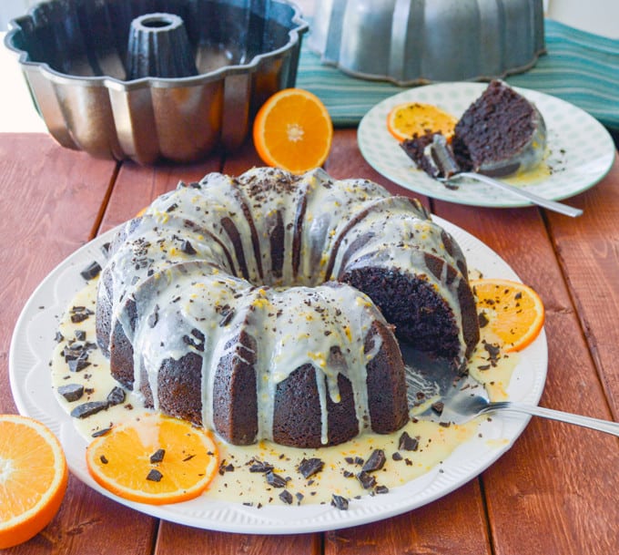 Orange Chocolate Bundt Cake side view with slice and pans