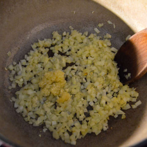 Adding minced garlic to tender onions