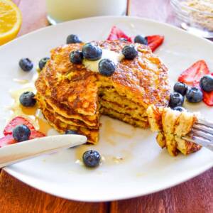 Lemon Buttermilk Rolled Oat Pancakes plated with berries
