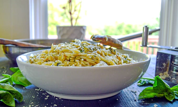 Simple Basil Parmesan Orzo in serving bowl with bail on table