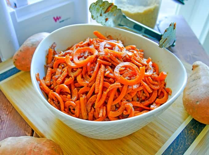 Spiralized Sweet Potato Noodles (Spoodles) in serving bowl up close with tongs