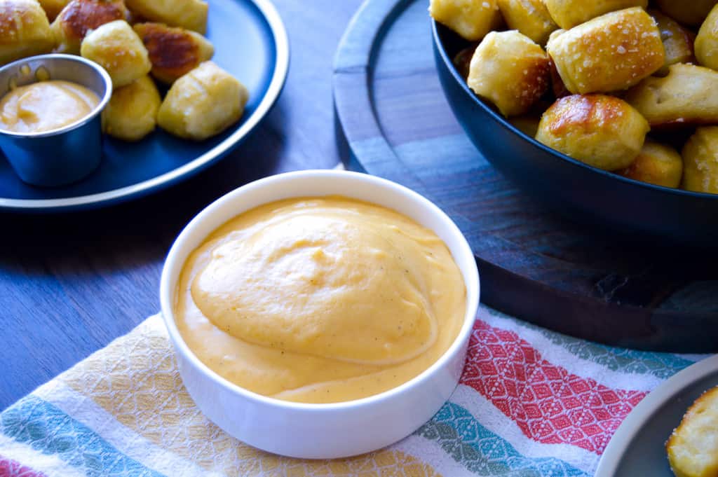 Beer Cheese Dip with a Beer and Bowl of Soft Pretzel bites