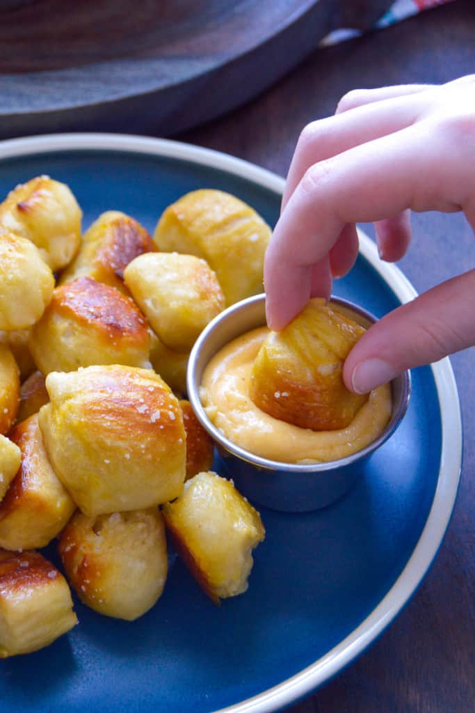 Dipping Soft Pretzel Bites into Cheese Sauce