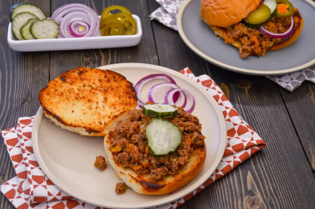 Open Bun Instant Pot Sloppy Joes with pickles on plate