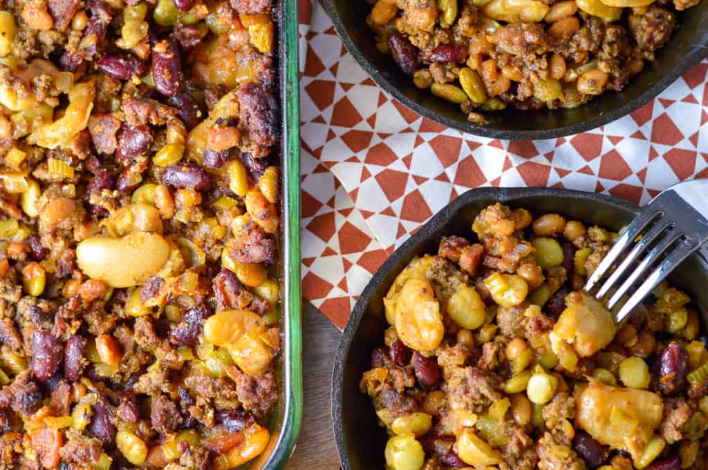 Caaaaaaaaaaaaaaaaaaaaaaaaaaaaaaaaaaaaaaaaaaaaaaaaalico Beans in Casserole Dish and cast iron skillets over red and white napkin