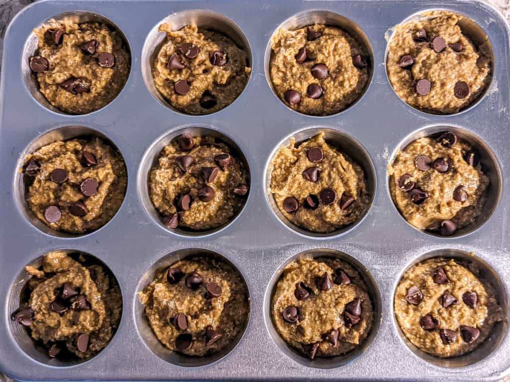 Steel cut oats muffin mixture in muffin tin pre-bake