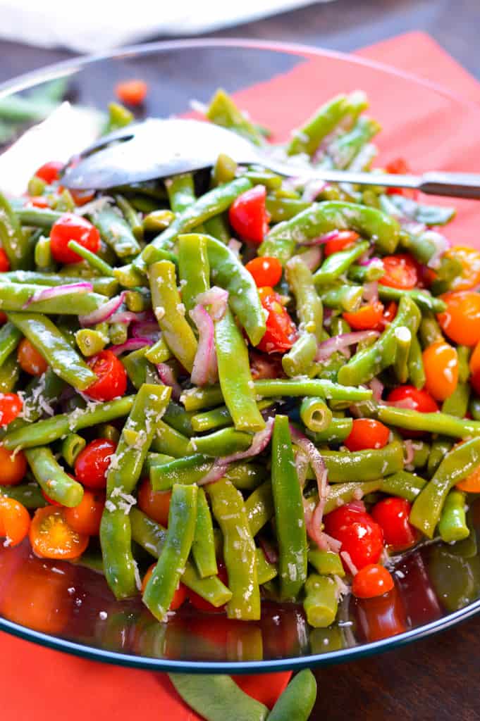 fresh green beans and tomatoes from the garden made into salad with serving spoon
