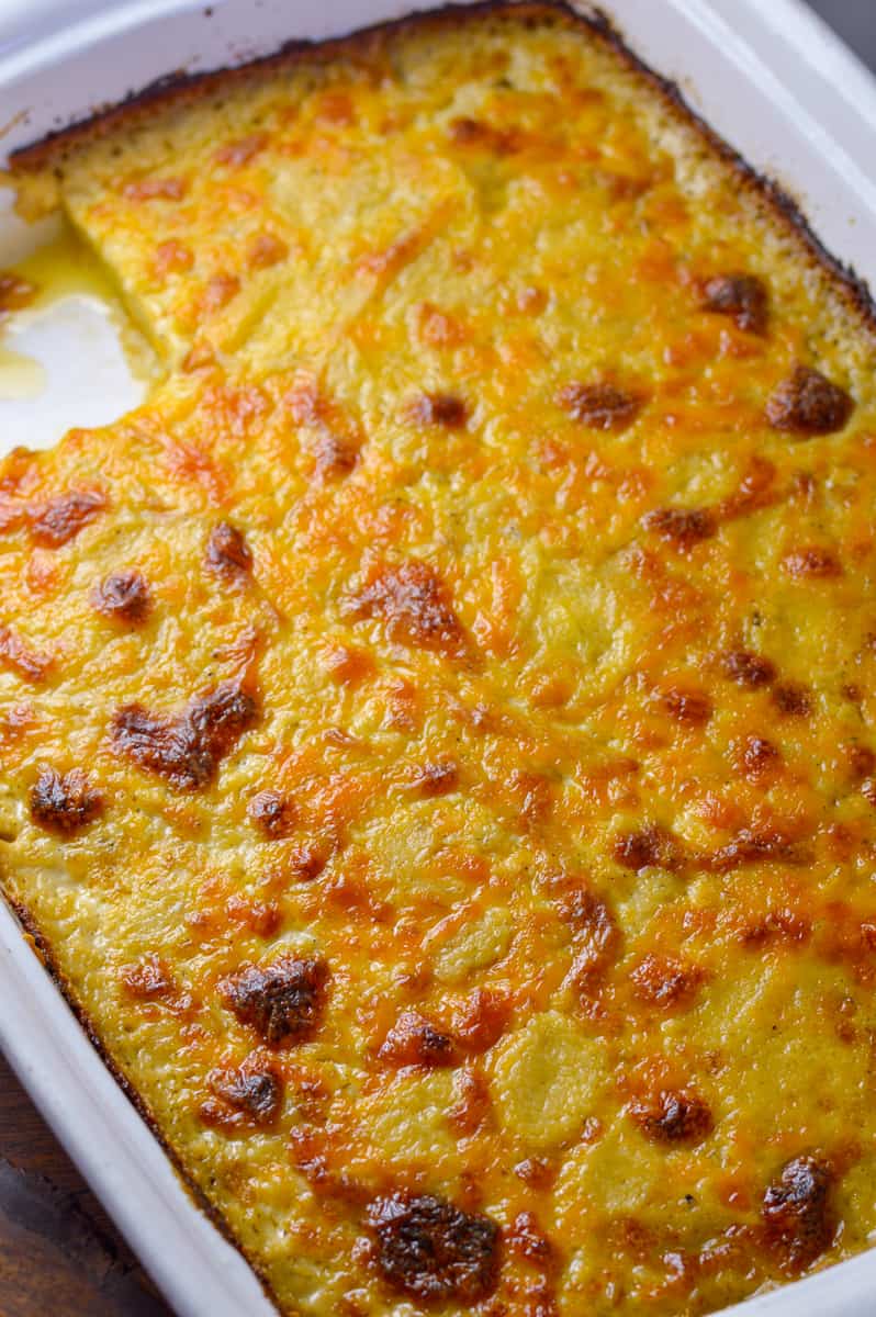 ¾ view of au gratin potatoes in baking dish with corner cut out