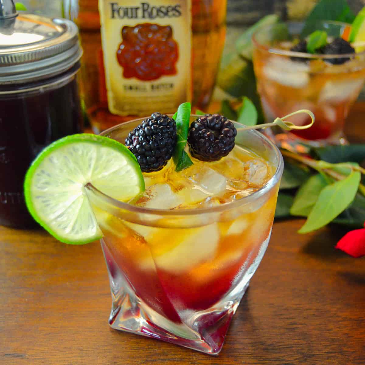 KY Blackberry Bourbon Cocktail with blackberries and lime on wooden table with Four Roses Bourbon 