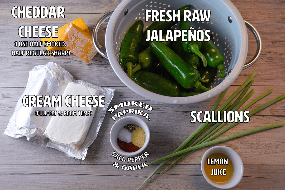Smoked Jalapeno poppers ingredients shown on wooden board with 5 ingredients plus 4 spices: cheddar cheese, raw jalapenos, cream cheese, scallions, lemon juice, smoked paprika, salt, pepper, and granulated garlic.