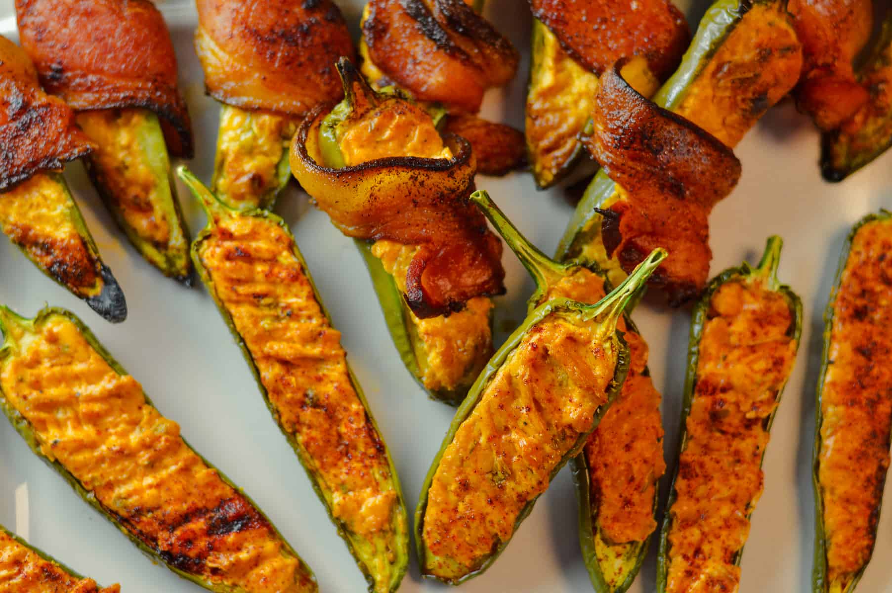 Image showing plain and bacon-wrapped jalapeno poppers on a white platter 