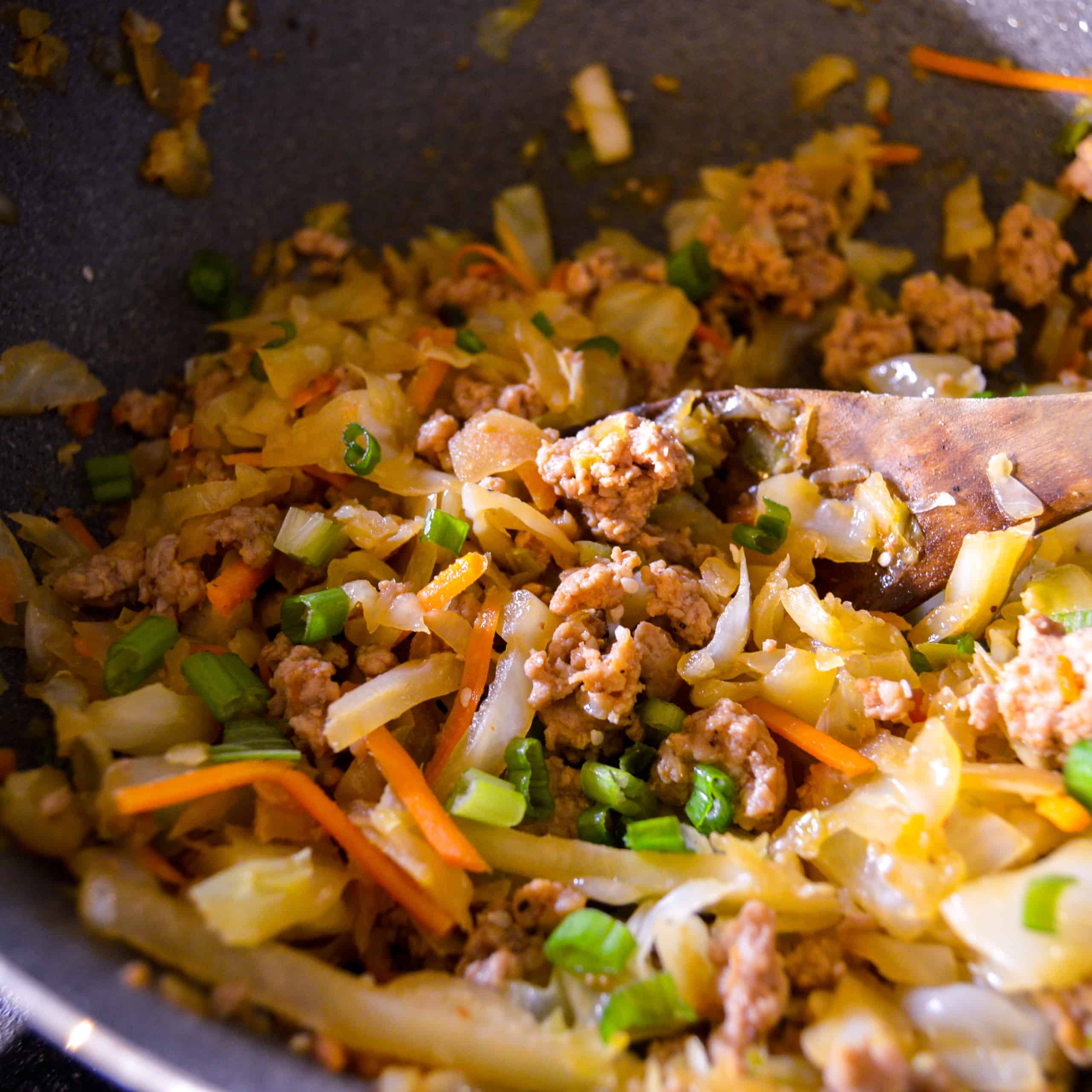 Inside Out Egg Roll I cooked in one pan, close up shot on wooden spoon. 