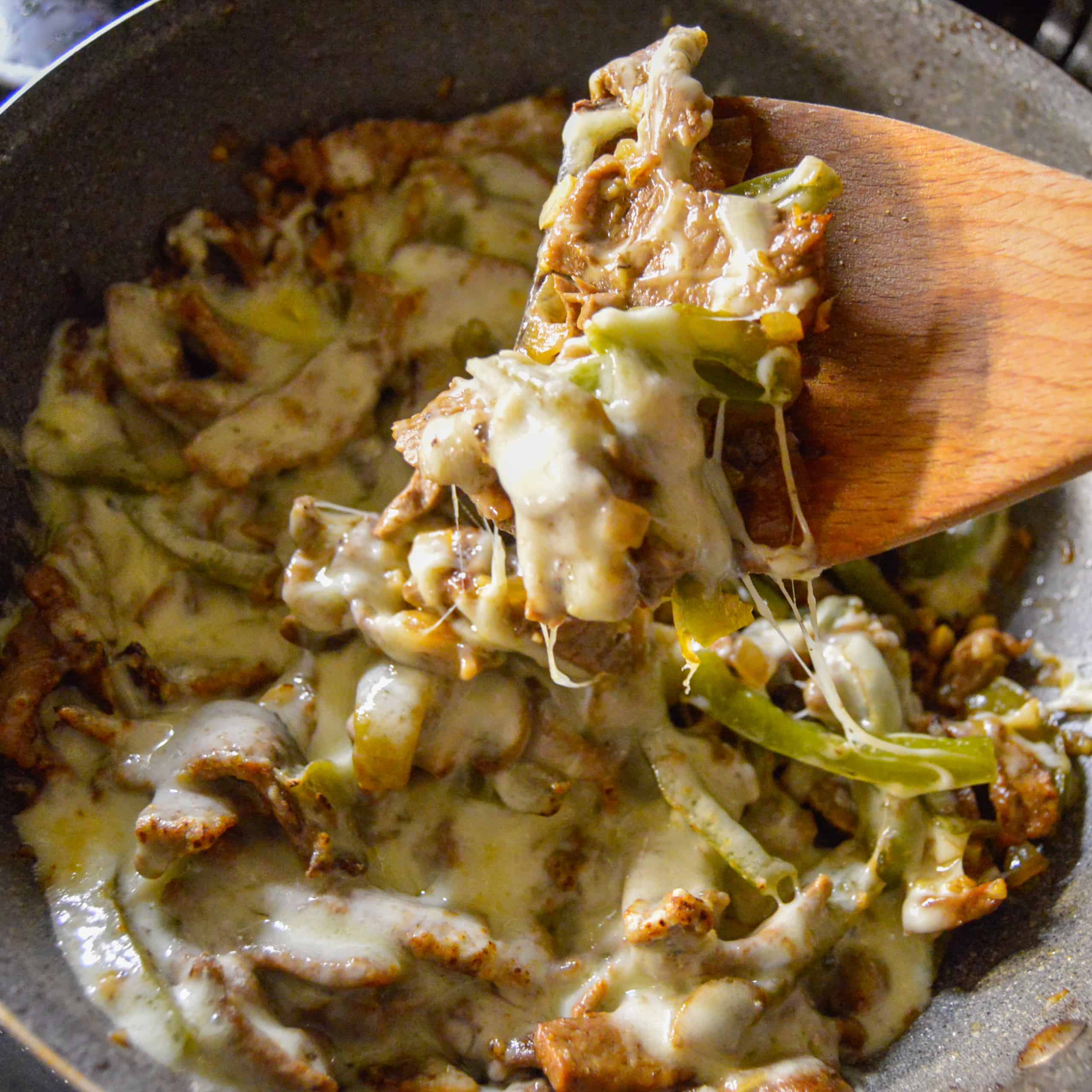 Low Philly Cheesesteak Skillet recipe I  cooked in one pan for dinner, cheesy close up shot on wooden spoon