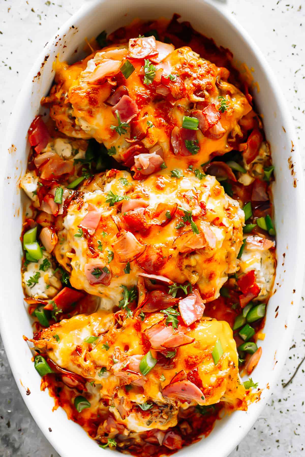 Diethood Crack Chicken Pinterest Pin showing baked chicken breasts with bacon cheese and green onion in casserole dish