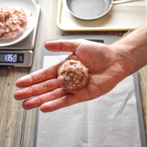 Balled up breakfast sausage mixture after being weighed.